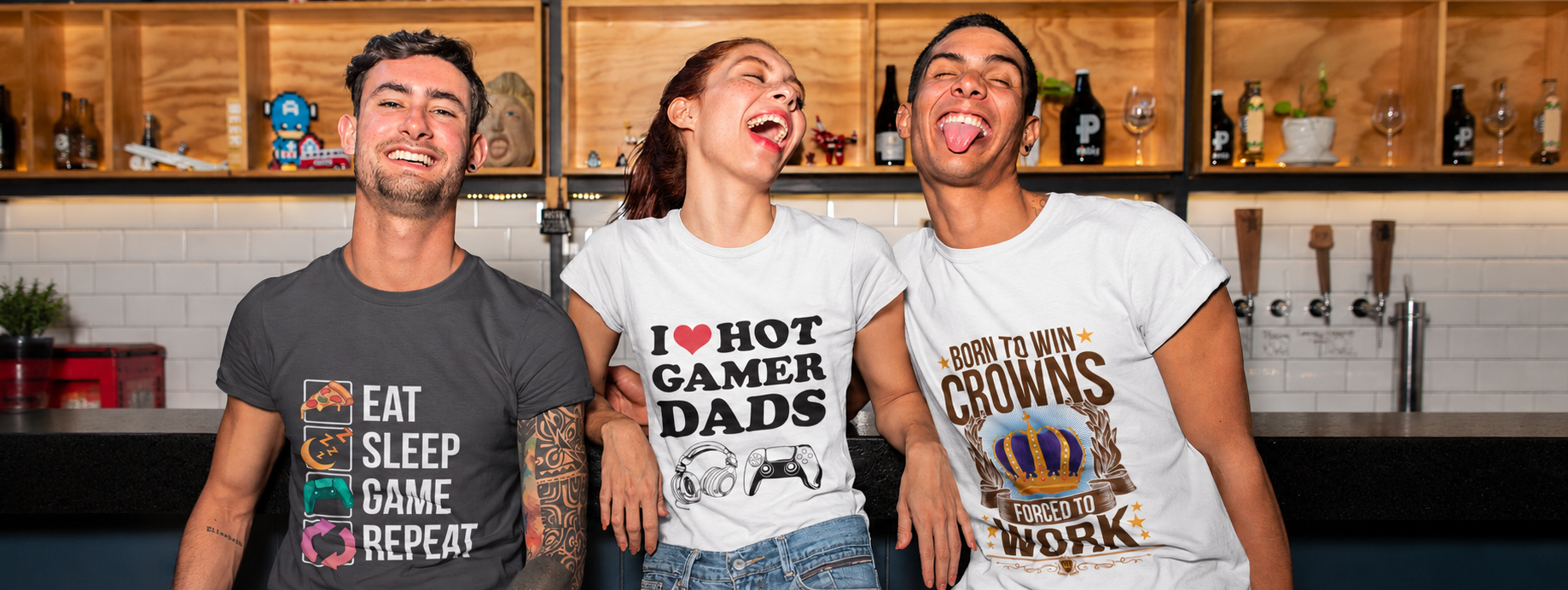 Three people wearing t-shirts with humorous text designs in a kitchen setting.