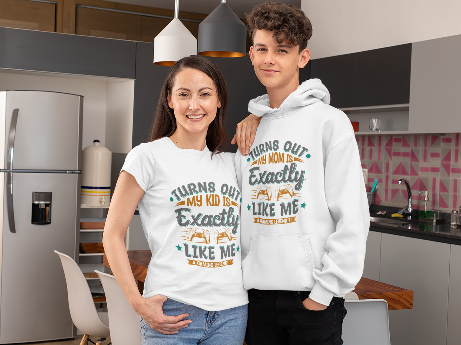 Two people standing in a kitchen wearing matching shirts with humorous text.